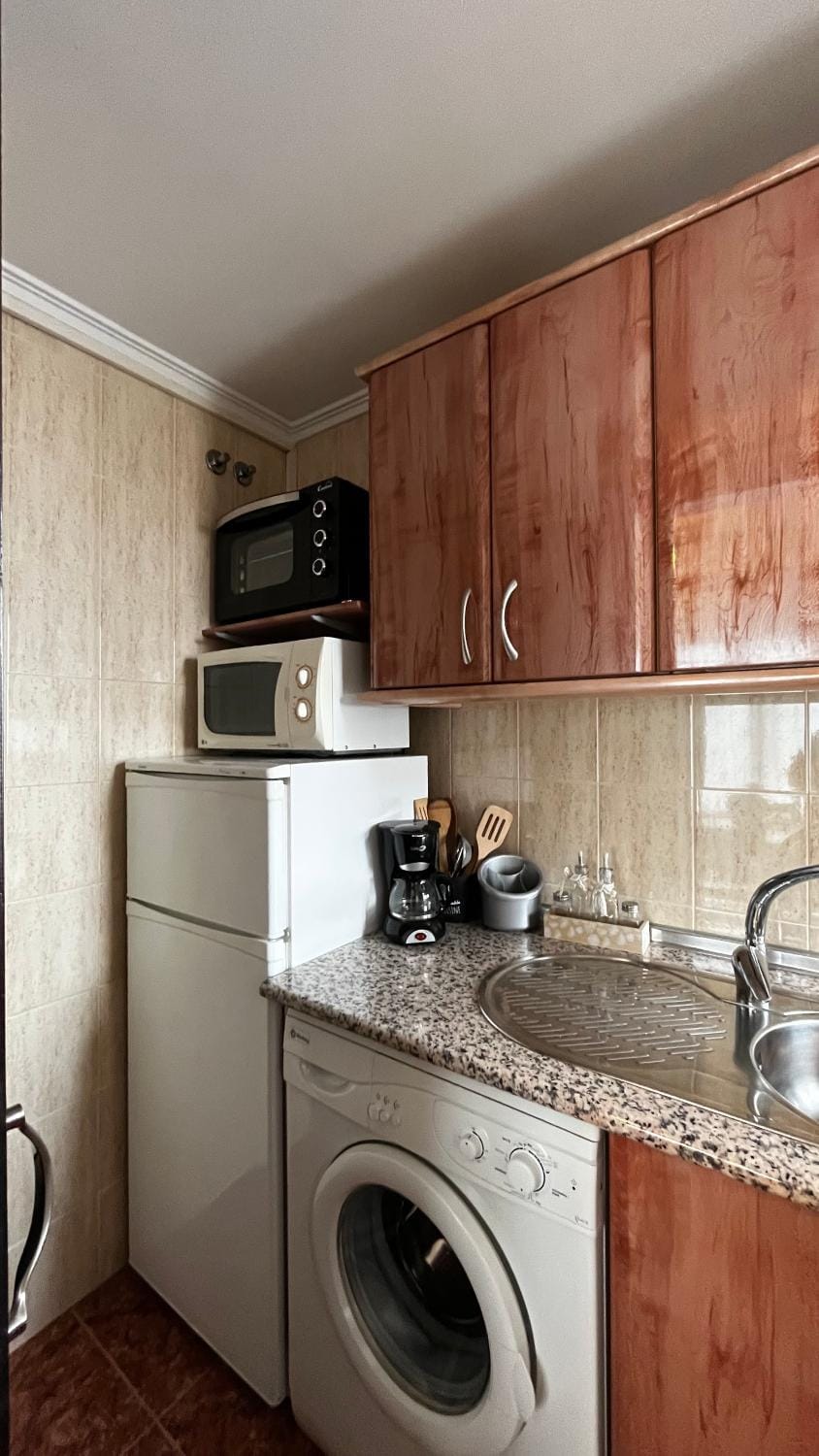 Kitchen or kitchenette, oven, stove, toaster, washing machine