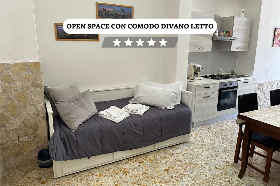 Bed, TV and multimedia, Kitchen or kitchenette, Living room, Photo of the whole room, Seating area, Text overlay, pet friendly, towels