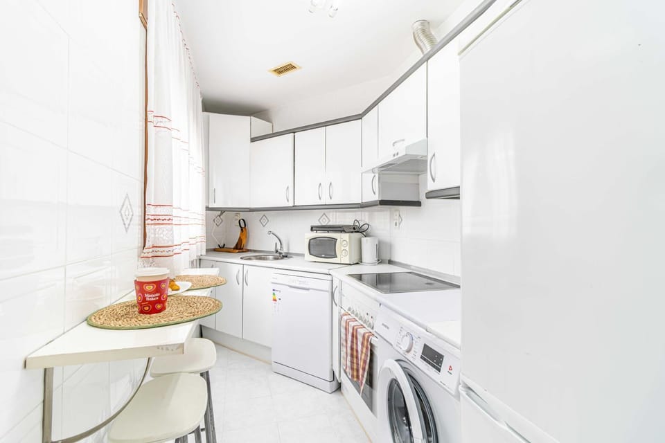Kitchen or kitchenette, dishwasher, oven, stove, washing machine