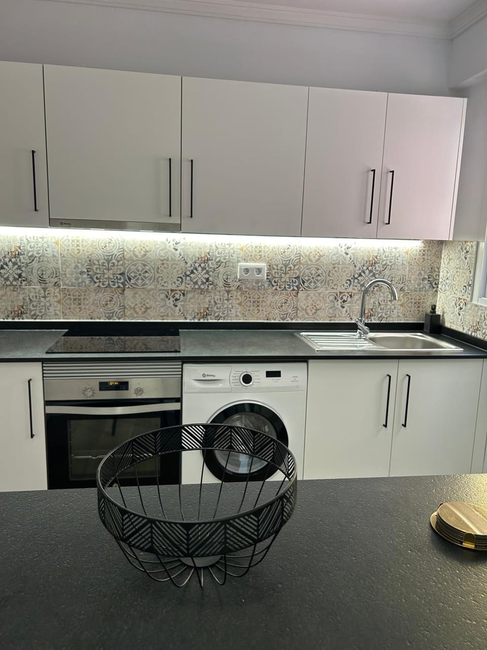Kitchen or kitchenette, oven, stove, washing machine