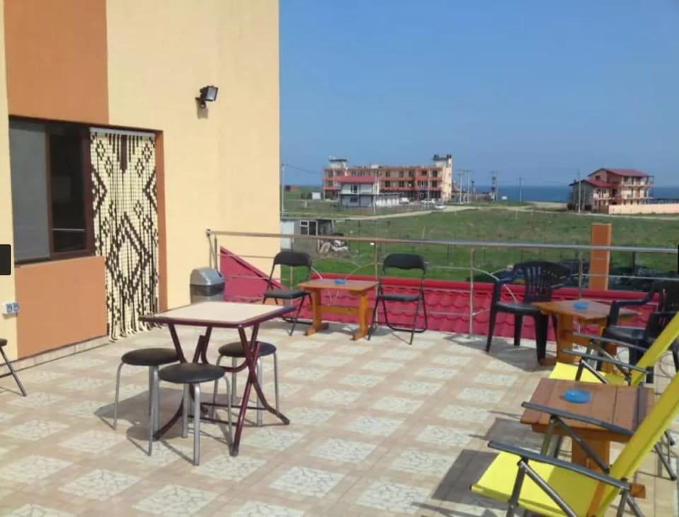 Property building, Natural landscape, View (from property/room), Living room, Seating area, Dining area, Sea view