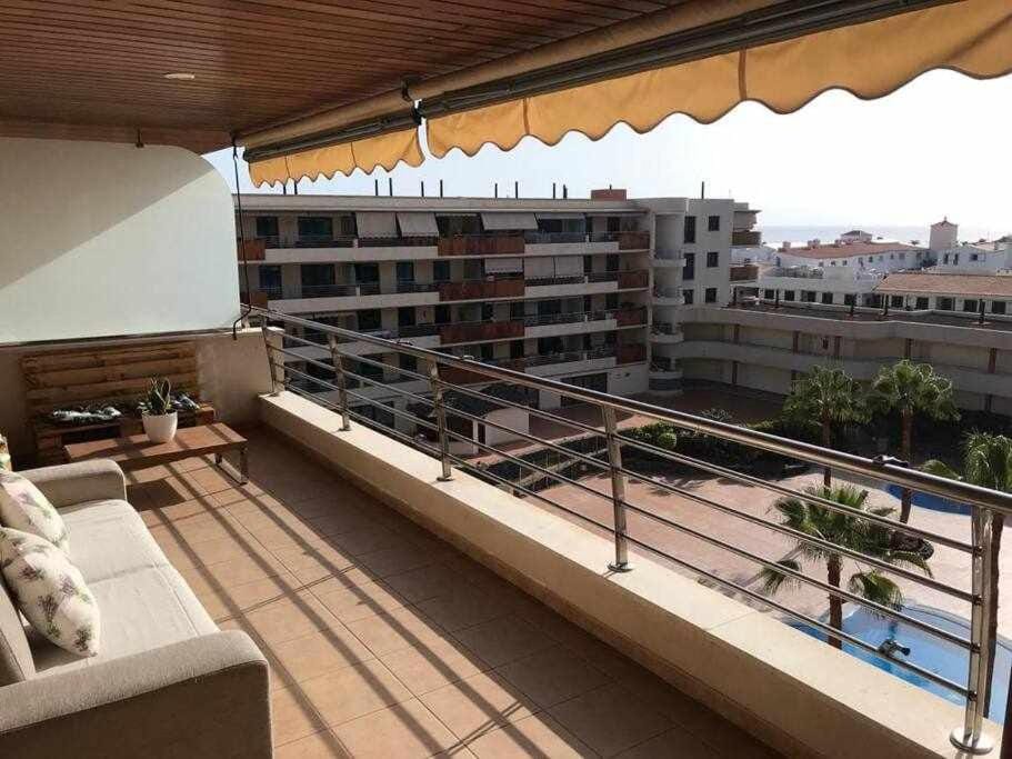 Property building, Patio, Day, View (from property/room), Balcony/Terrace, Balcony/Terrace, Living room, Seating area, City view, Pool view, Swimming pool, sunbed