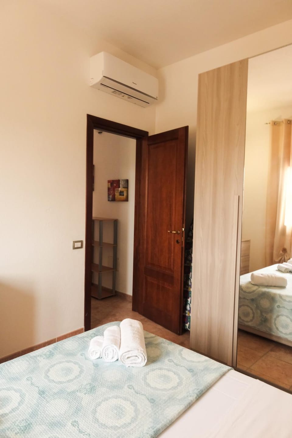 Bed, towels, wardrobe, air conditioner