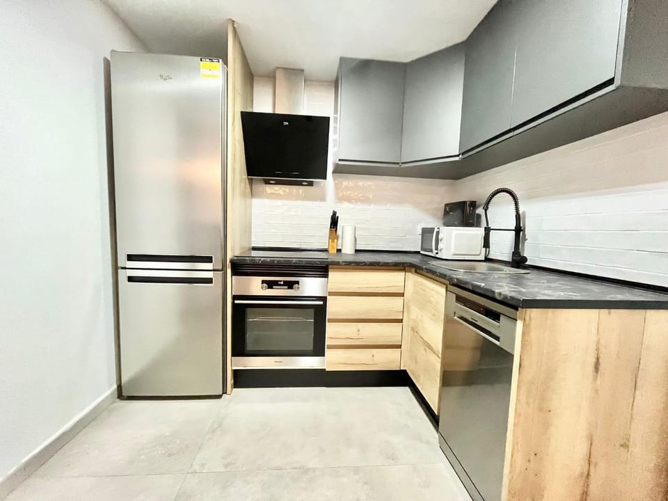 Kitchen or kitchenette, dishwasher, oven, stove