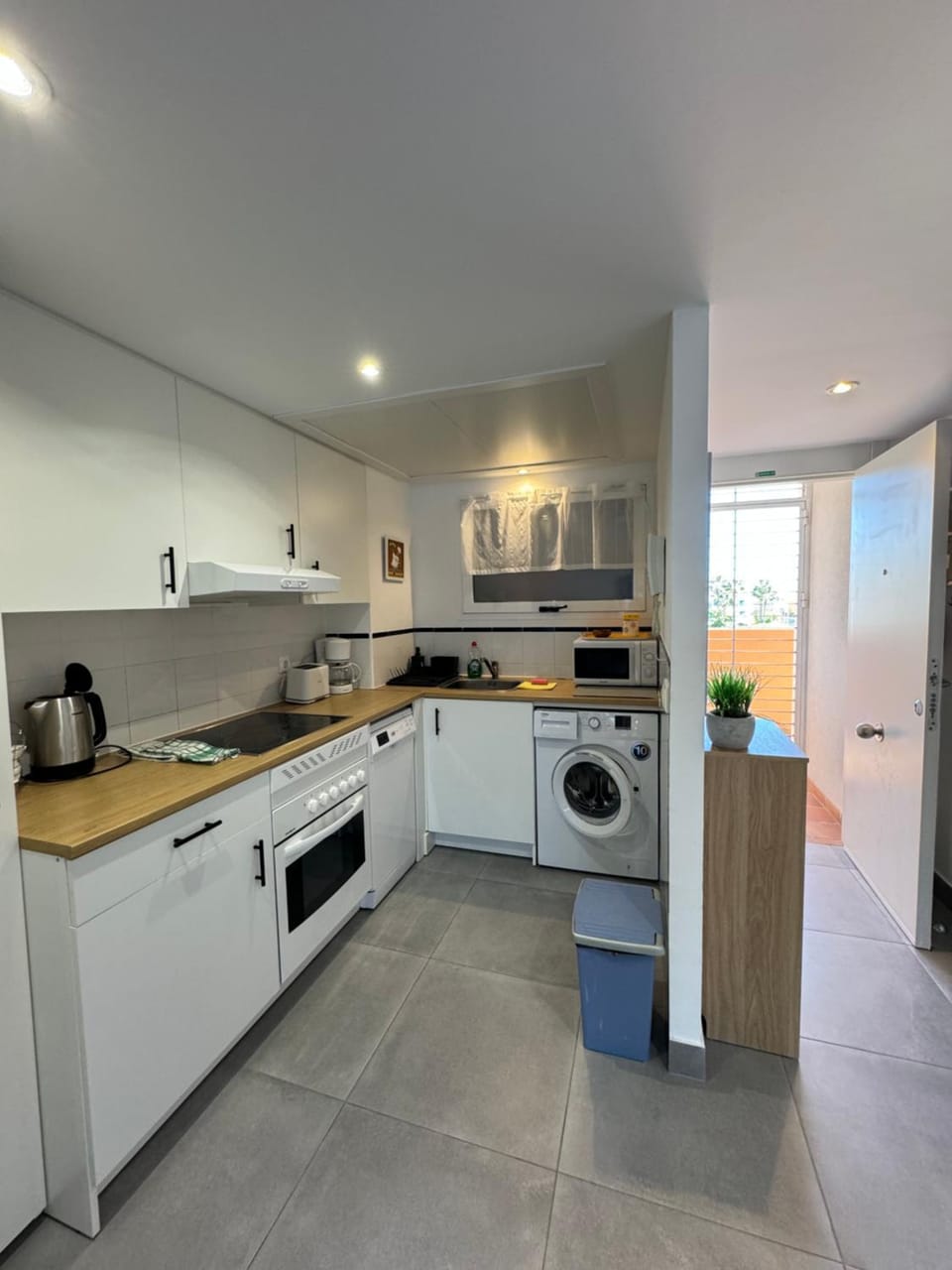 Kitchen or kitchenette, dishwasher, oven, stove, toaster, washing machine