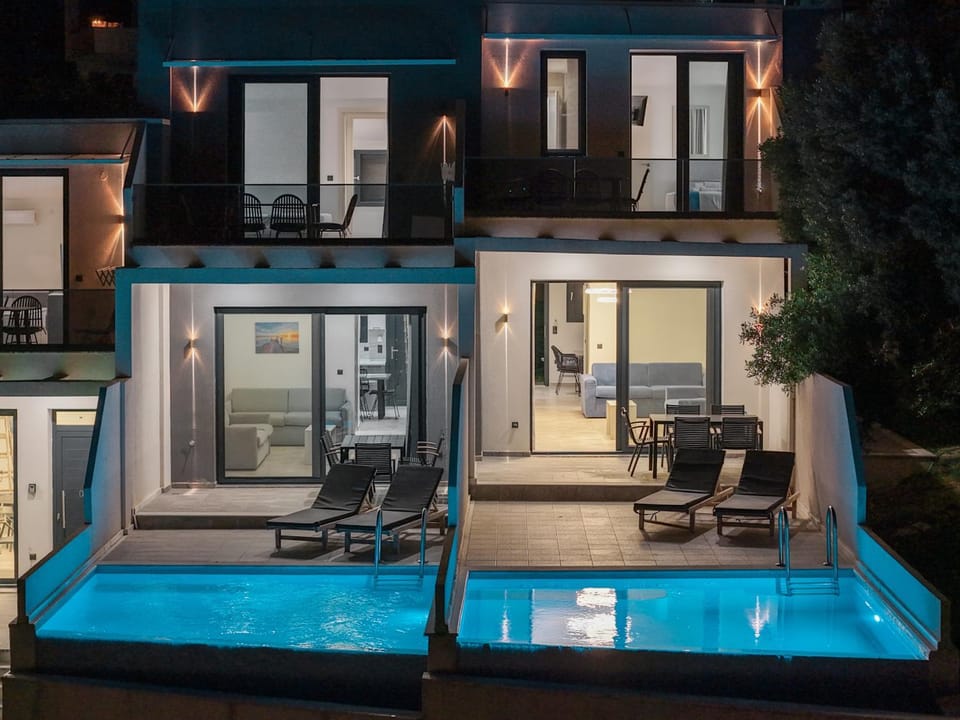 Property building, Patio, Night, Seating area, Pool view, Swimming pool, sunbed