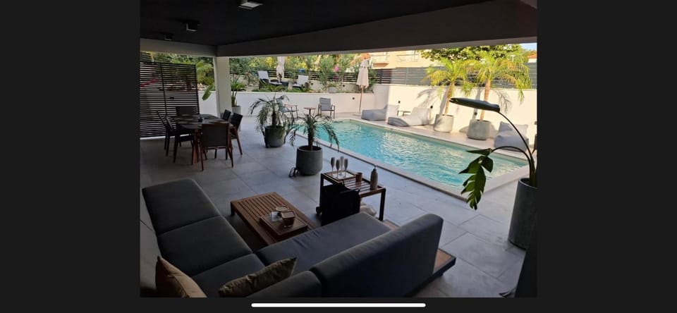 Patio, Day, Seating area, Pool view, Swimming pool, sunbed