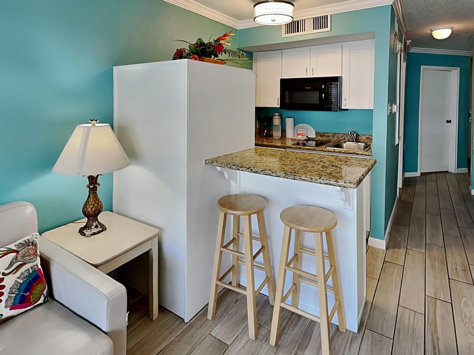 Kitchen or kitchenette, Seating area, furniture, microwave, air conditioner