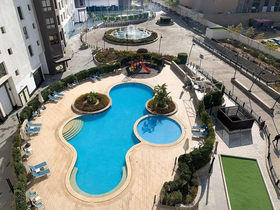 Lovely 2 bedroom duplex with a pool in front AUC Apartment in New Cairo City