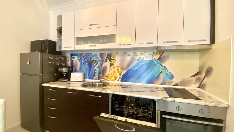 Kitchen or kitchenette, dishwasher, microwave, oven, stove