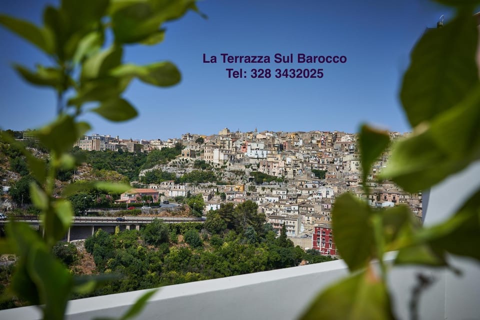 Nearby landmark, Natural landscape, Text overlay, City view, Mountain view