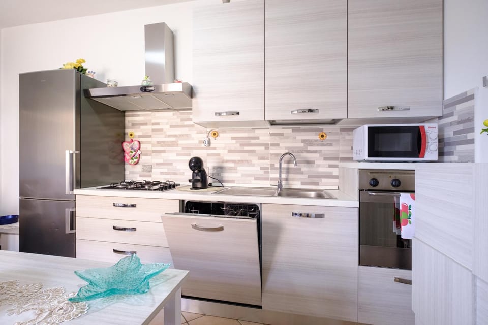 Kitchen or kitchenette, dishwasher, oven, stove