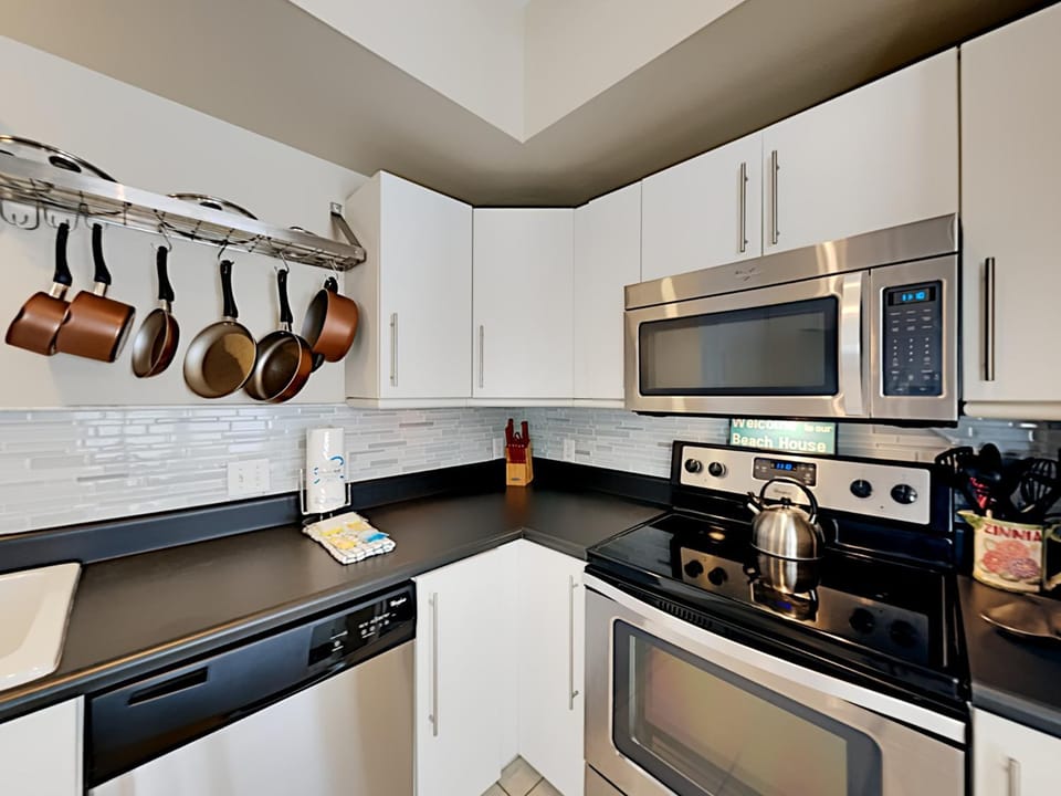 Kitchen or kitchenette, dishwasher, microwave, oven, stove