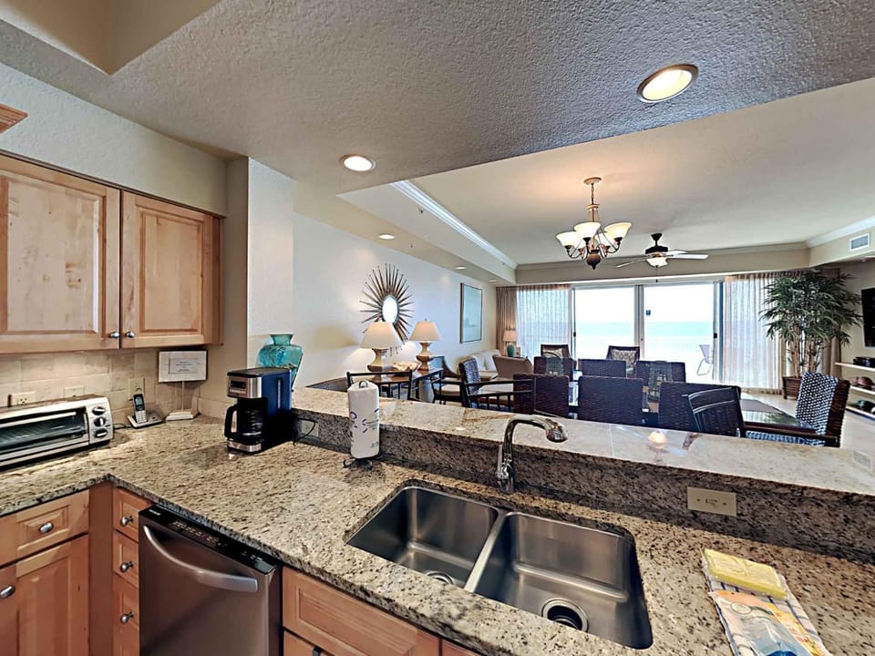 View (from property/room), Kitchen or kitchenette, Living room, Dining area, Sea view, dishwasher, furniture, microwave, toaster, air conditioner