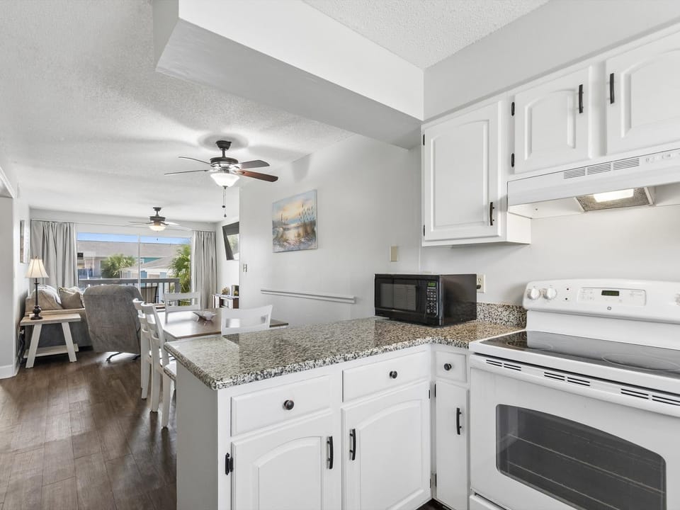 TV and multimedia, Kitchen or kitchenette, Living room, Seating area, Dining area, furniture, microwave, oven, stove