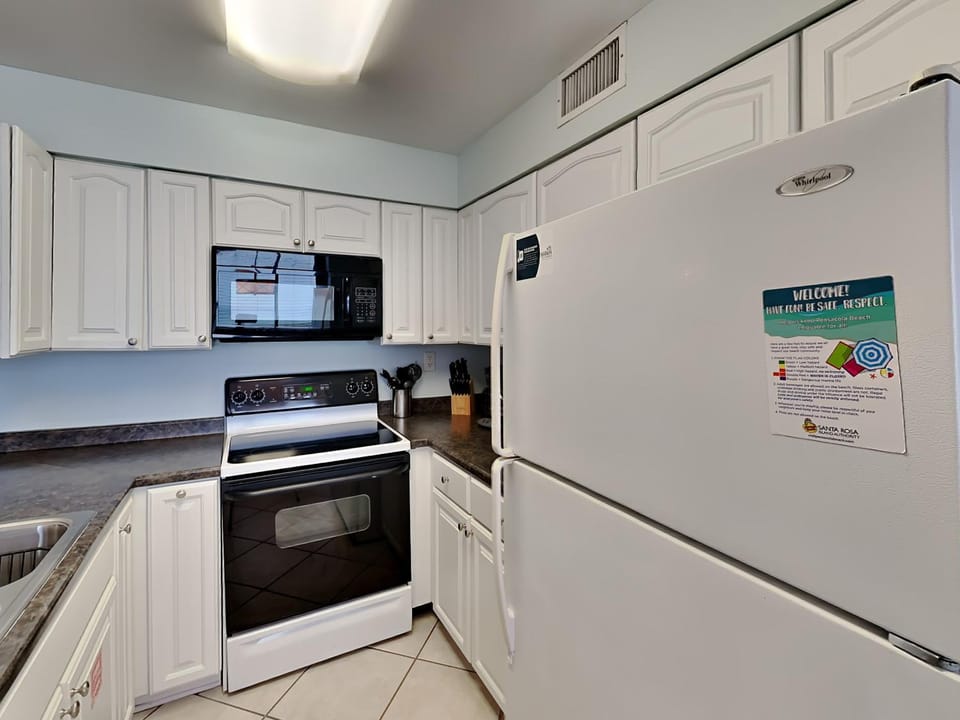 Kitchen or kitchenette, microwave, oven, stove, kitchen, air conditioner
