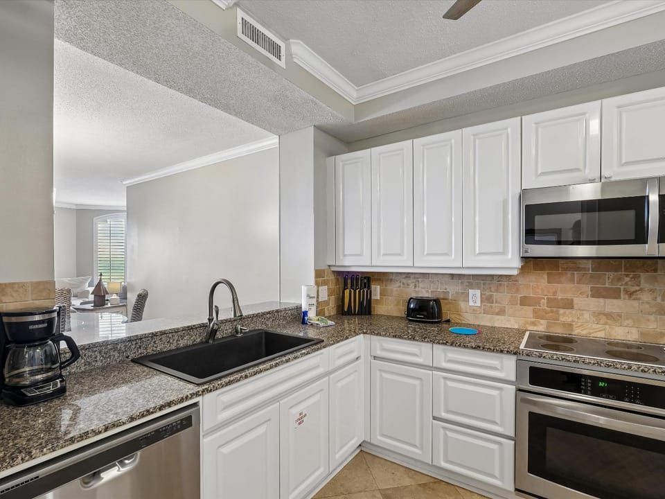 Kitchen or kitchenette, microwave, oven, stove, kitchen, air conditioner
