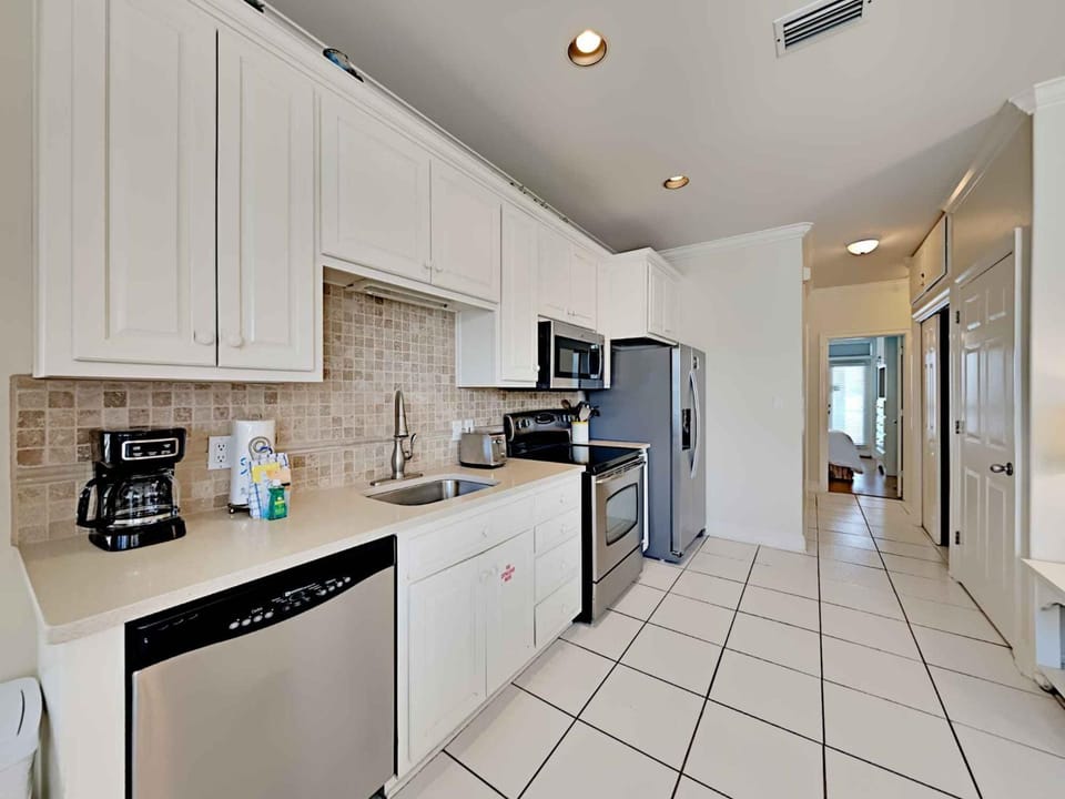 Kitchen or kitchenette, microwave, oven, stove, washing machine, kitchen, air conditioner