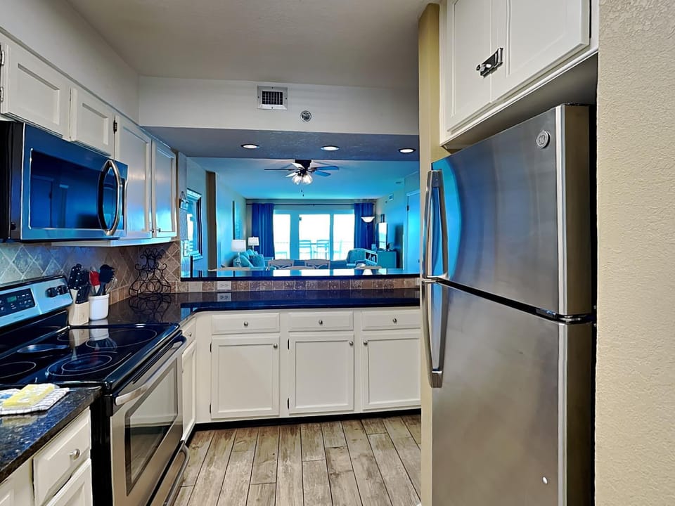 Kitchen or kitchenette, Living room, furniture, microwave, stove, air conditioner