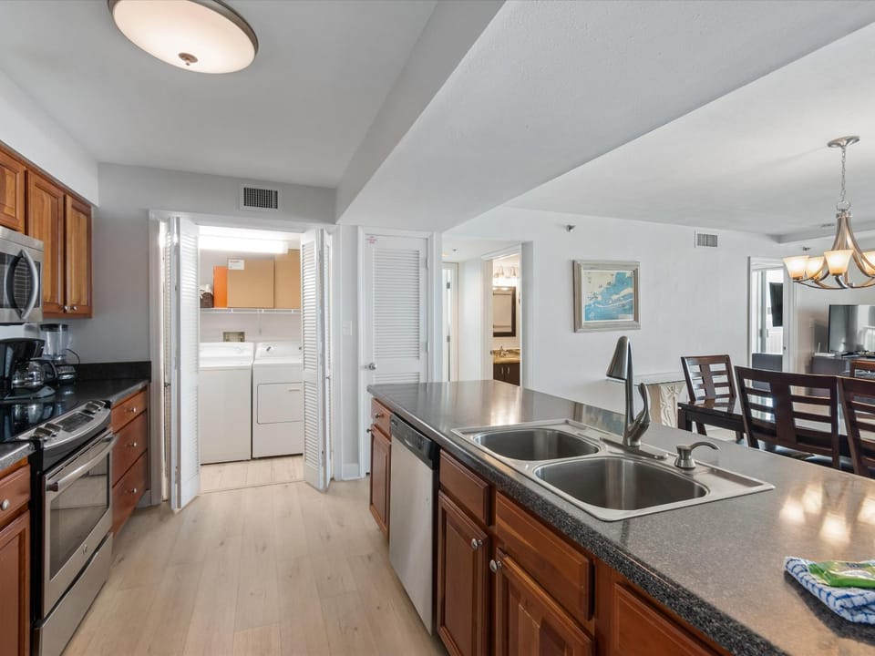 Kitchen or kitchenette, Seating area, Dining area, furniture, microwave, stove, laundry, washing machine, air conditioner