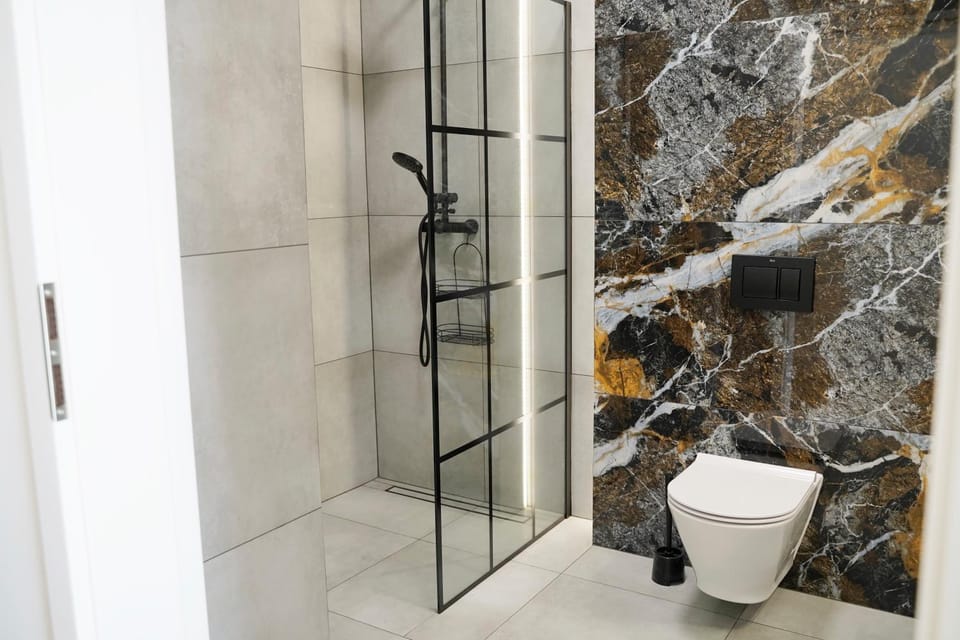 Shower, Toilet, Bathroom, flat iron, hair dryier, towels, laundry, washing machine, dryer