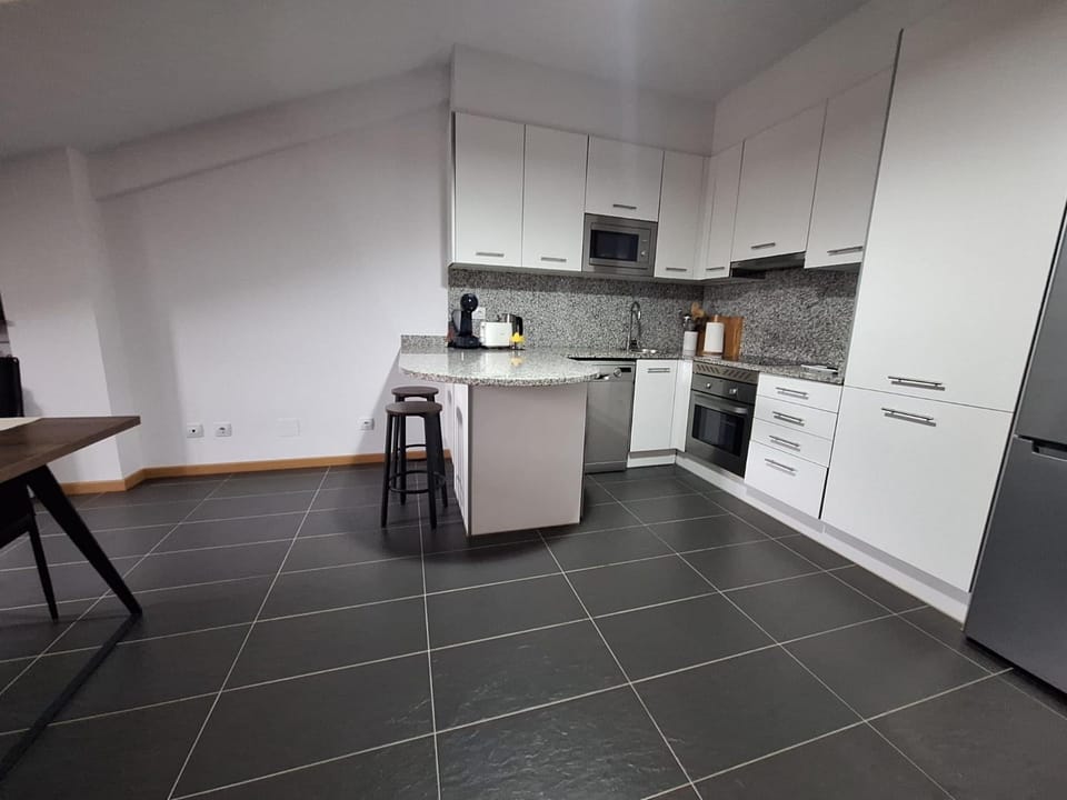 Kitchen or kitchenette, dishwasher, oven, stove