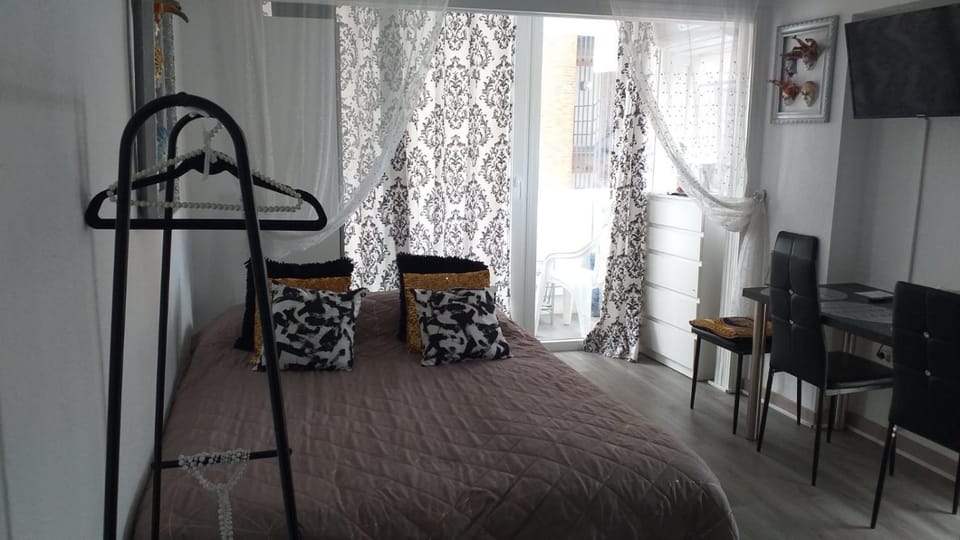Bed, TV and multimedia, Living room, Seating area, wardrobe