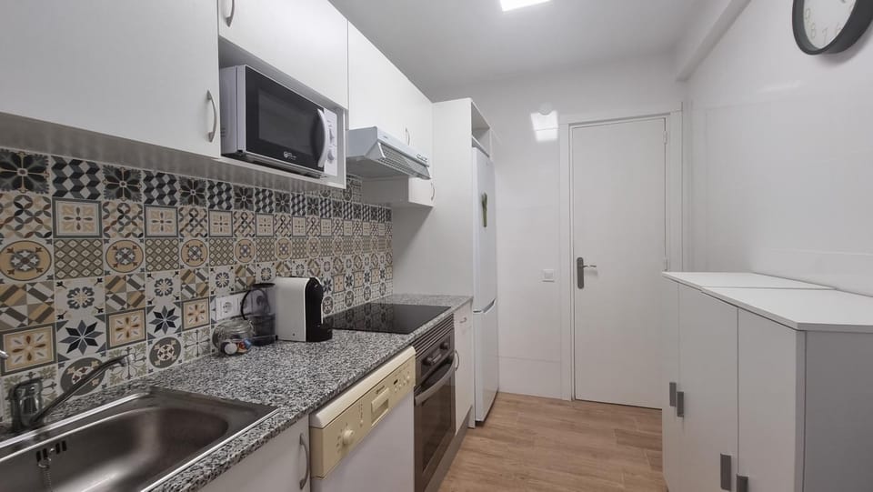 Kitchen or kitchenette, dishwasher, oven, stove