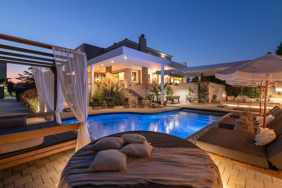 Property building, Patio, Night, Seating area, Pool view, Swimming pool