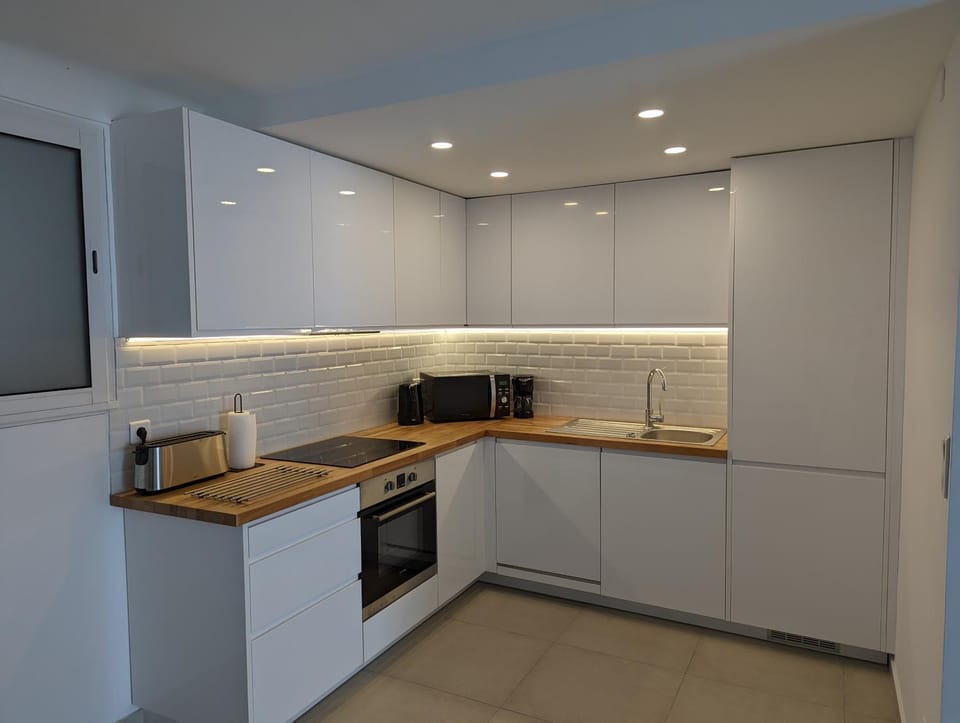 Kitchen or kitchenette, dishwasher, microwave, oven, stove, toaster