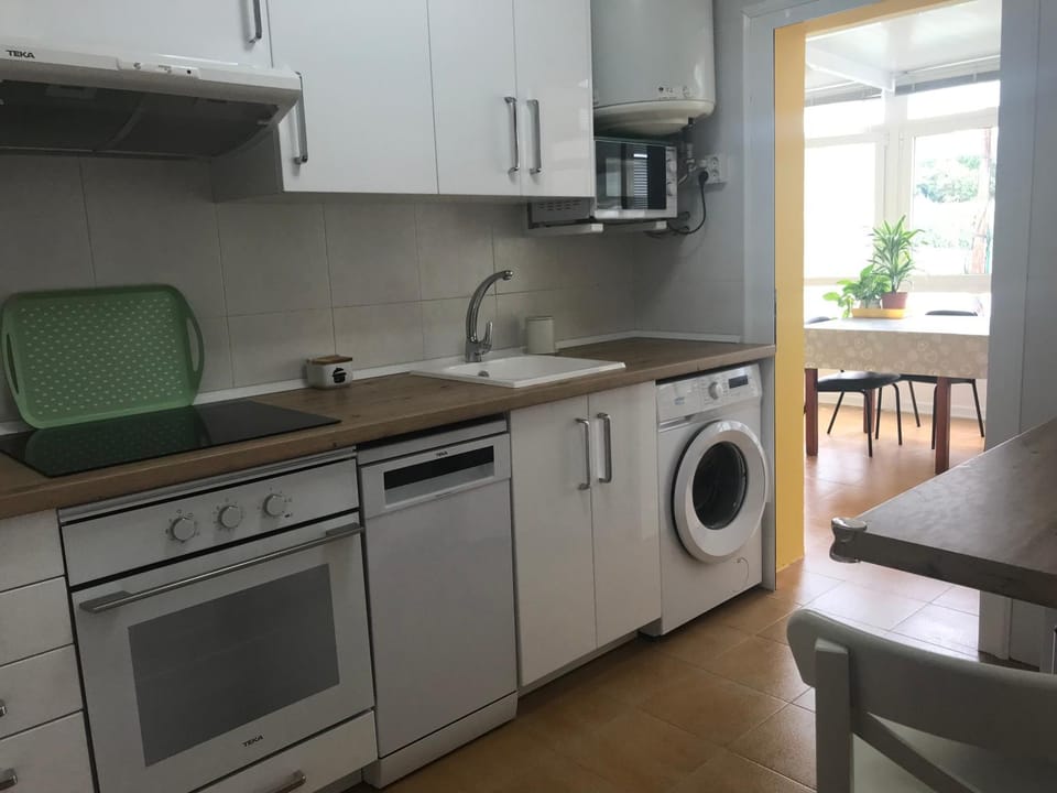 Kitchen or kitchenette, dishwasher, oven, stove, toaster, washing machine