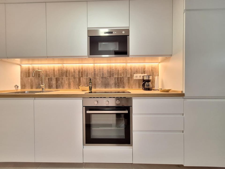 Coffee/tea facilities, microwave, oven, storage, stove, washing machine, kitchen