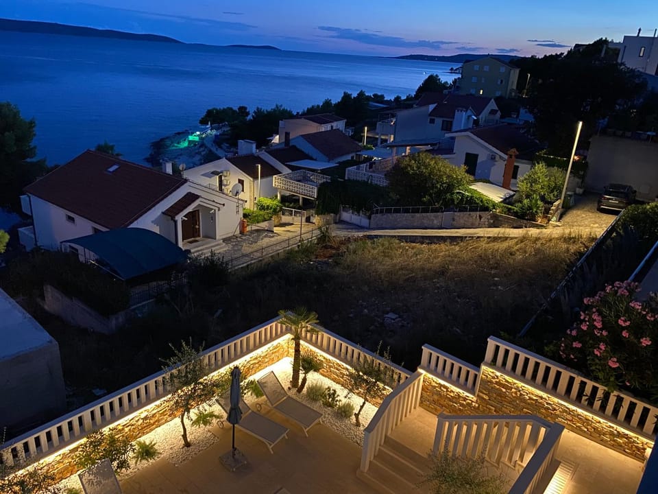 Property building, Patio, Night, Natural landscape, Sea view, Sunset