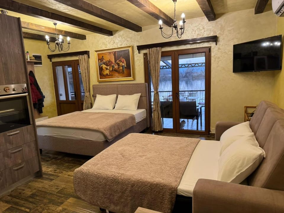 Bed, TV and multimedia, Living room, Seating area, Bedroom