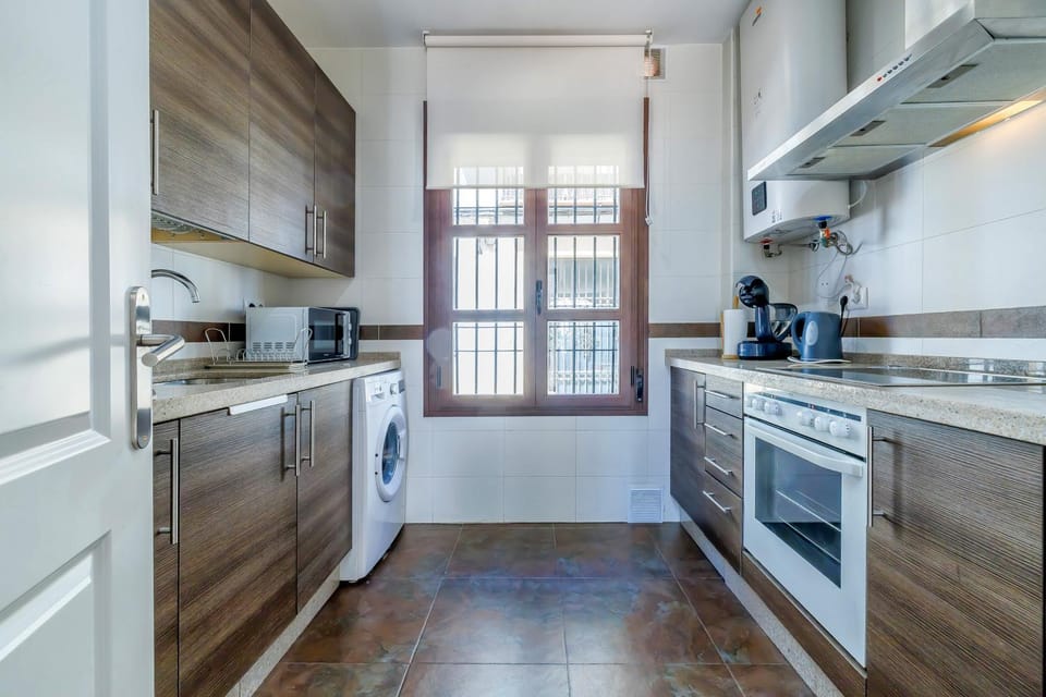 Kitchen or kitchenette, microwave, oven, stove, toaster, washing machine