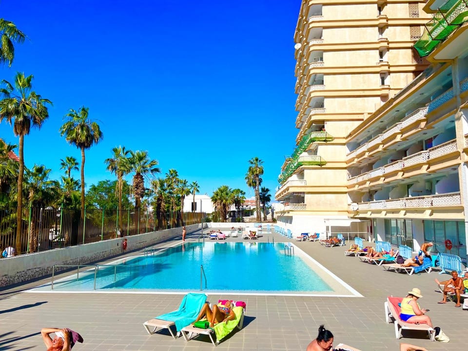 Pool view, Swimming pool, group of guests, sunbed