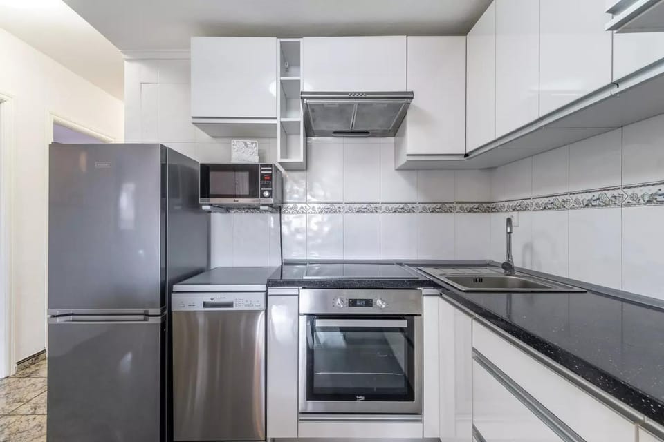 Kitchen or kitchenette, dishwasher, oven, stove