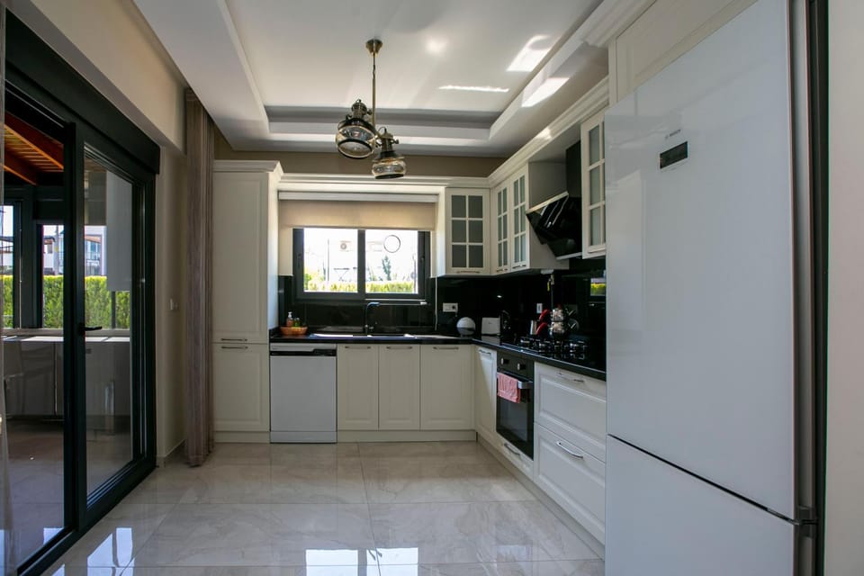 Kitchen or kitchenette, dishwasher, oven, stove