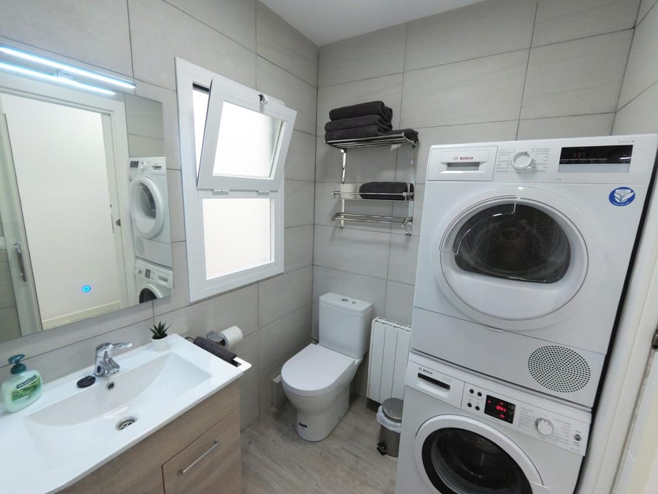 Toilet, towels, washing machine, dryer