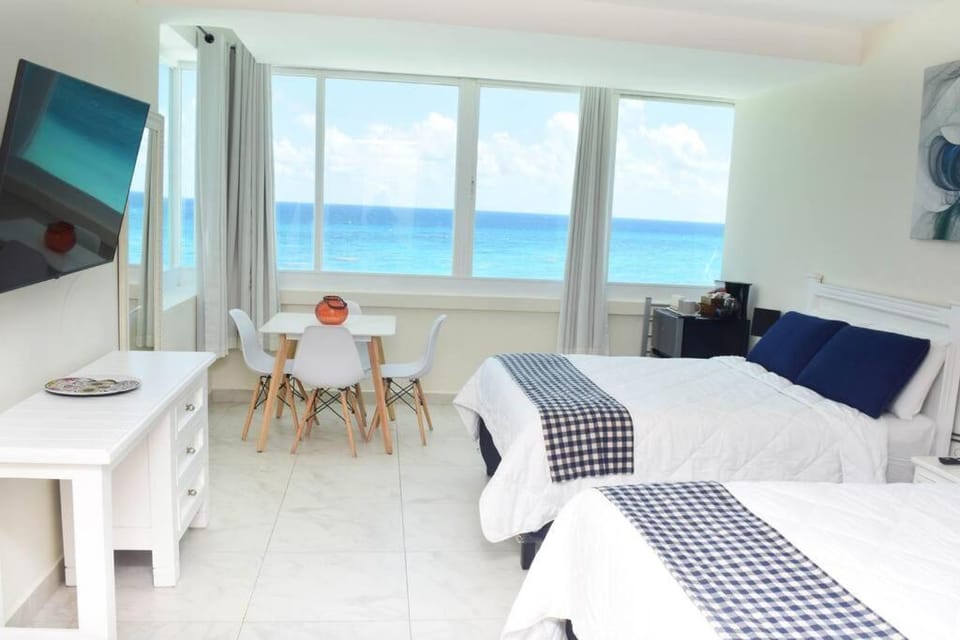 Bed, Natural landscape, TV and multimedia, Photo of the whole room, Seating area, Beach, Bedroom, Sea view, internet, air conditioner