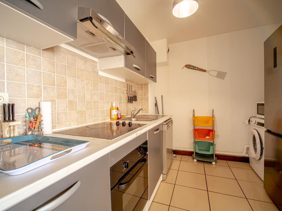 Kitchen or kitchenette, dishwasher, microwave, oven, stove, washing machine