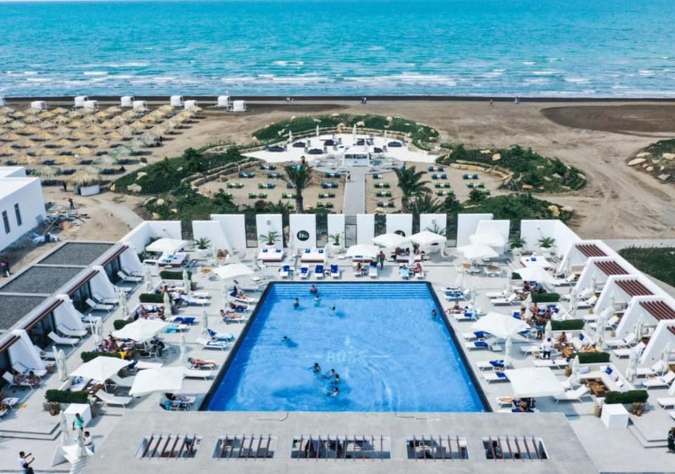 Nearby landmark, Communal lounge/ TV room, Day, People, Natural landscape, Bird's eye view, Beach, Evening entertainment, Pool view, Sea view, Swimming pool, group of guests, sunbed