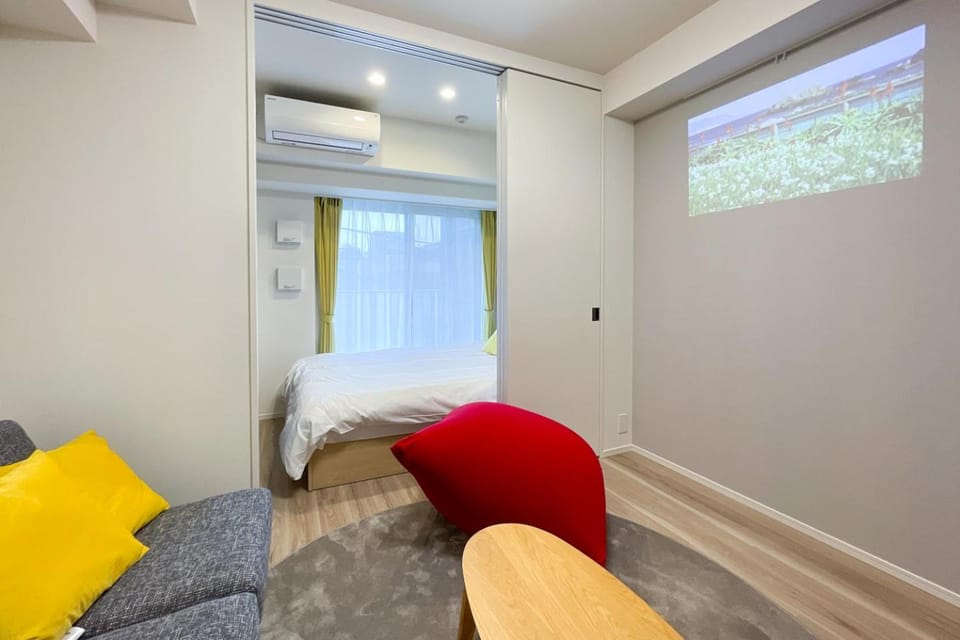 Bed, TV and multimedia, Living room, Seating area, Bedroom, air conditioner