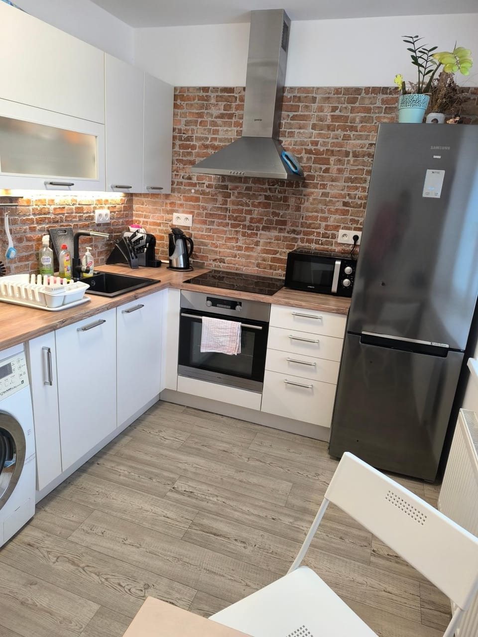 Kitchen or kitchenette, dishwasher, microwave, oven, stove, washing machine