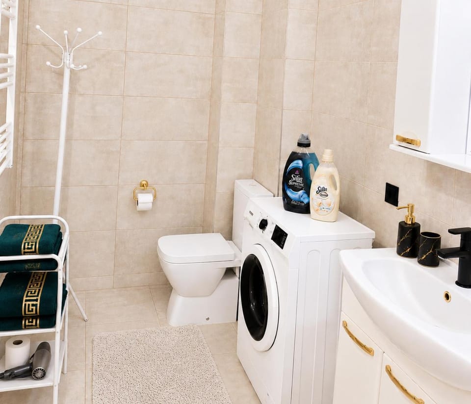 Toilet, Bathroom, towels, washing machine, dryer