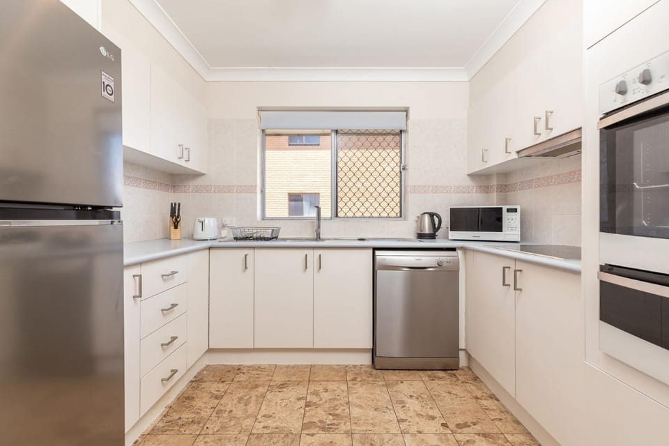 Kitchen or kitchenette, dishwasher, oven, stove
