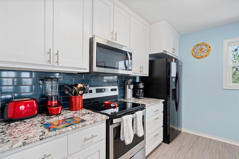 Kitchen or kitchenette, microwave, oven, stove, towels