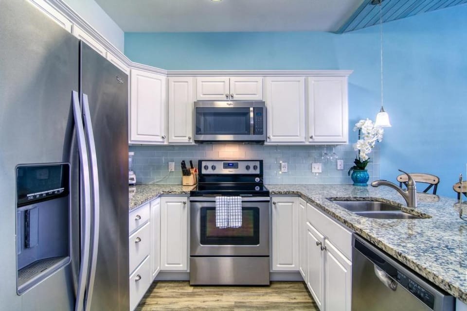 Kitchen or kitchenette, dishwasher, microwave, oven, stove