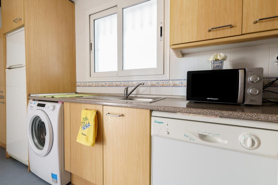 Kitchen or kitchenette, dishwasher, oven, stove, washing machine
