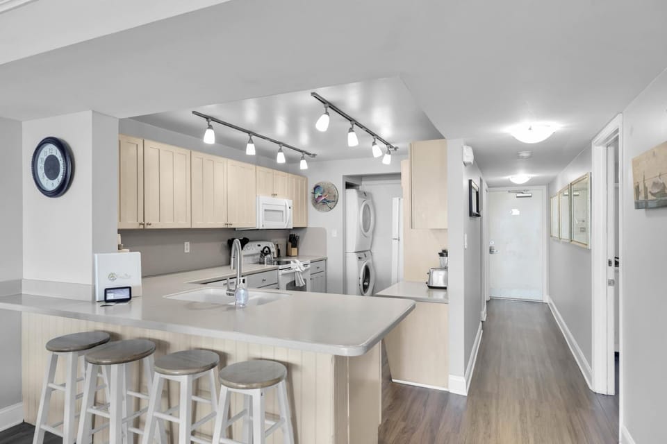 Kitchen or kitchenette, dishwasher, oven, stove, laundry